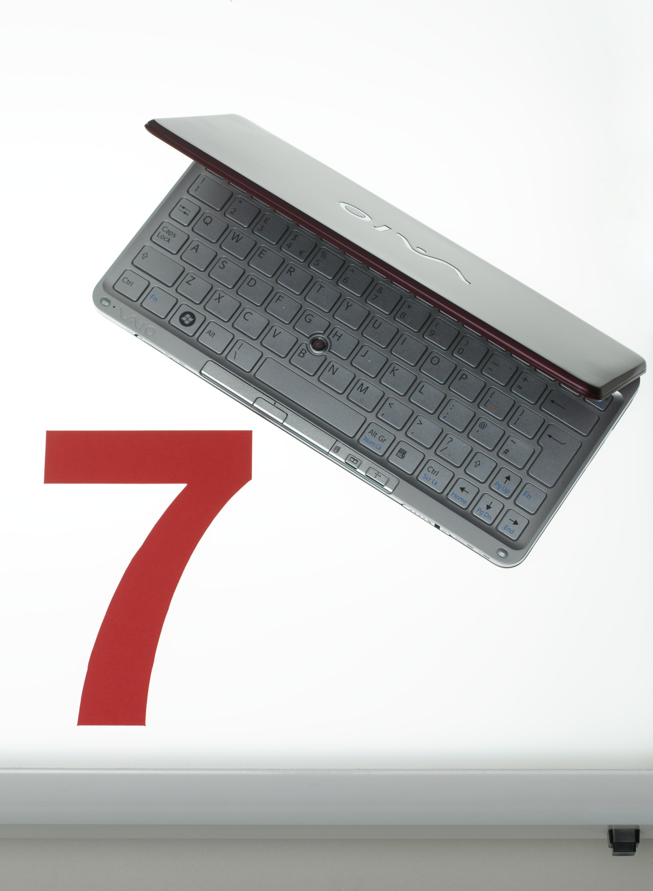 Sony VAIO P-series ultraportable laptop with burgundy accents displayed next to large red number 7.