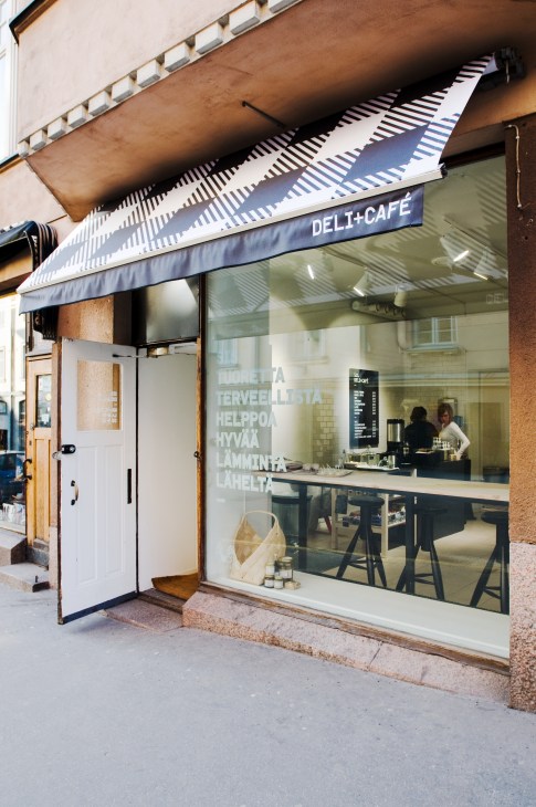 Sis deli-café storefront on Korkeavuorenkatu with striped awning and large window display.