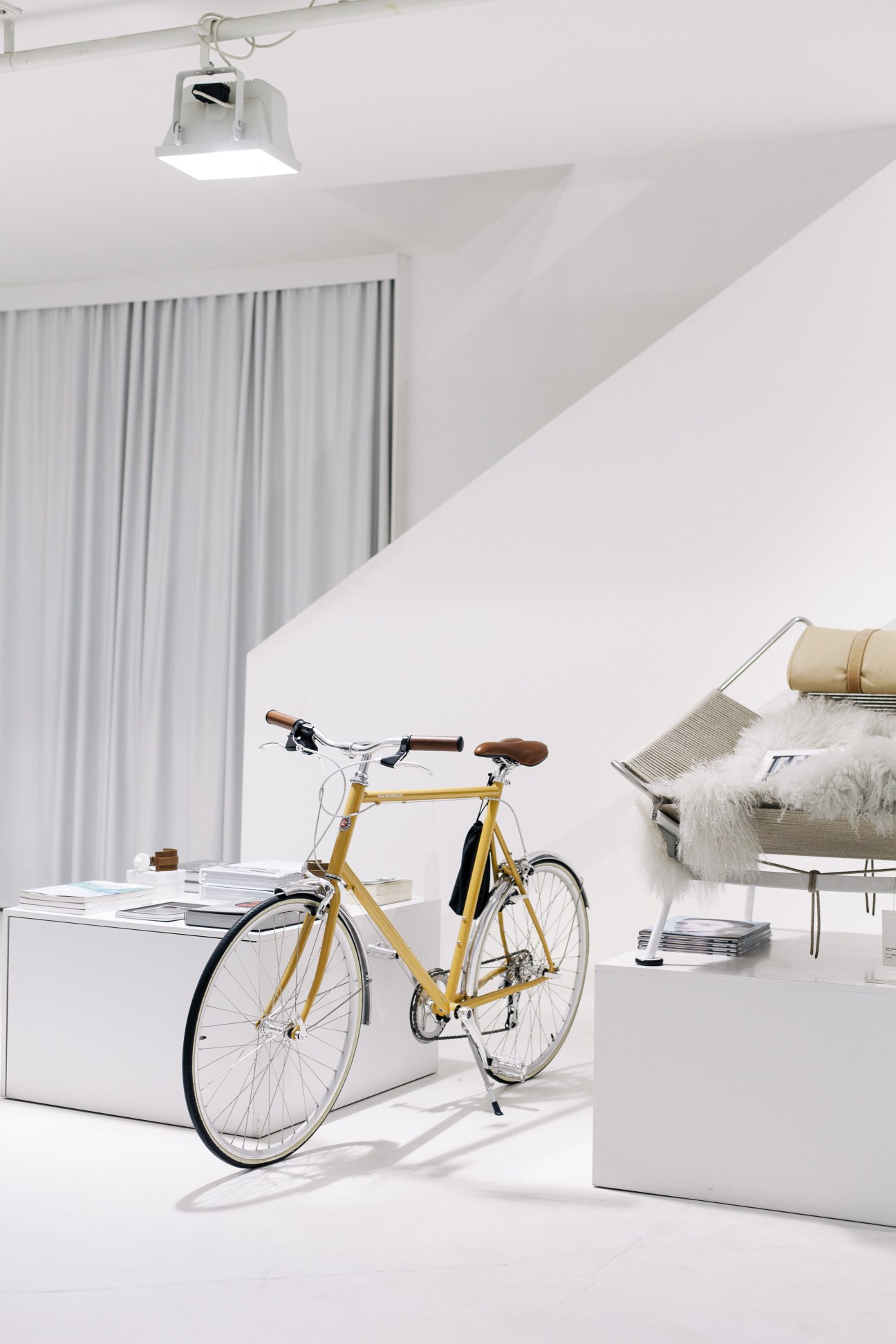 Minimalist interior space at Park concept store with gold bicycle and modern furnishings.