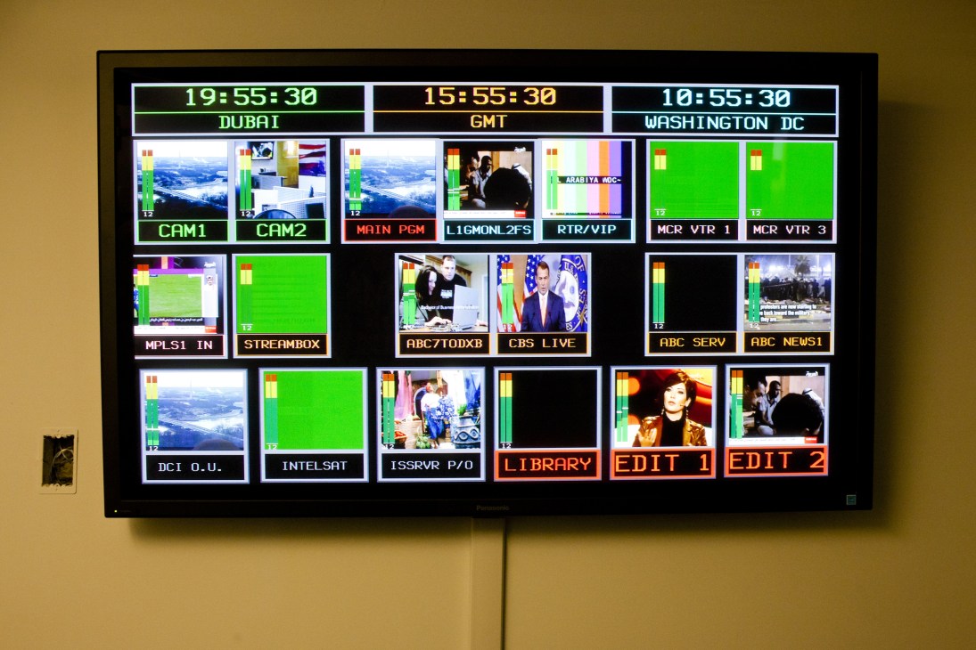Television control room monitor displaying multiple camera feeds and time zones for Dubai, GMT, and Washington DC.