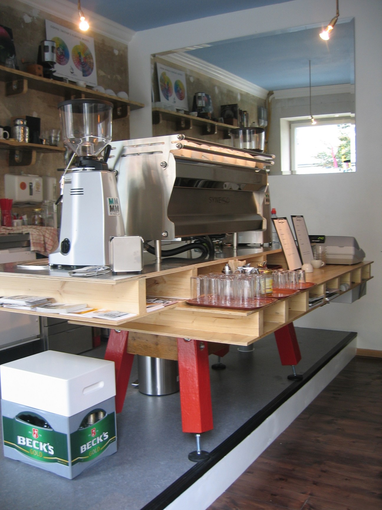 Coffee shop counter with espresso machine, grinder, and cups at Bonanza Coffee Heroes in Berlin.