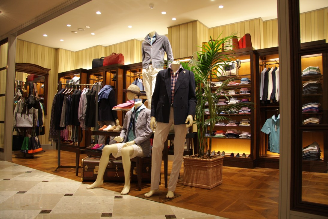 Interior of Beams House retail store with mannequins displaying menswear and womenswear collections on wooden displays.