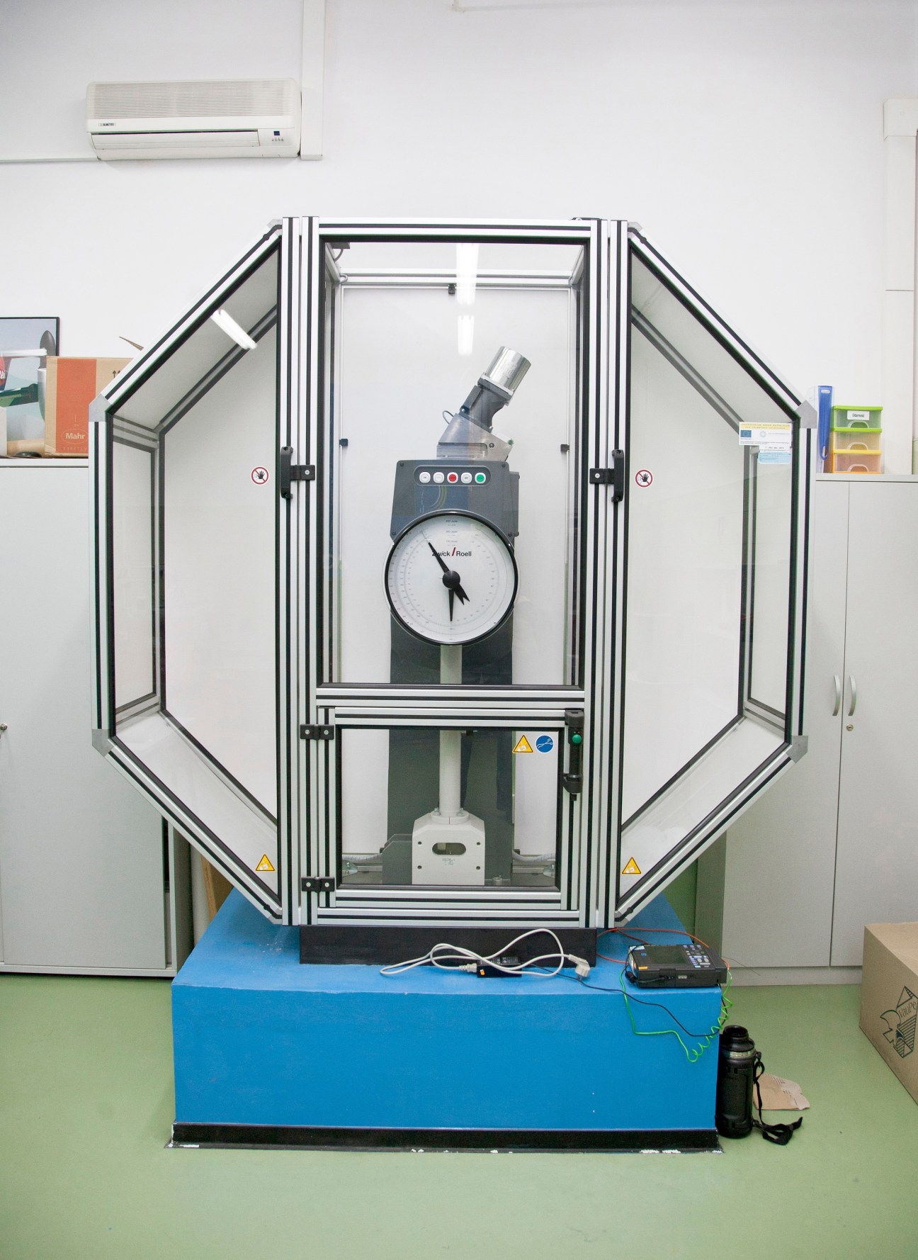 Impact tester machine with analog gauge inside protective chamber at Rzeszów's technical university.