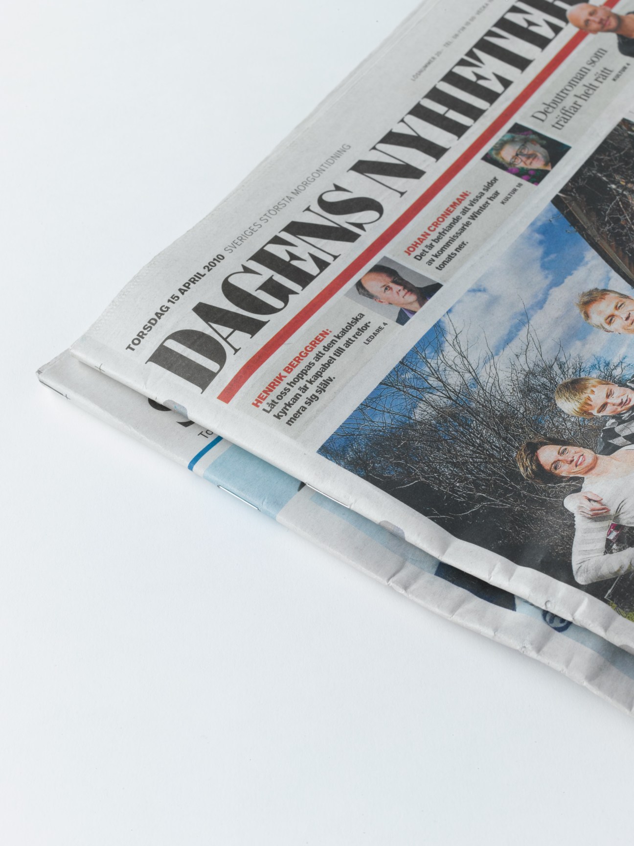 Close-up of folded Dagens Nyheter newspaper showing stitched spine binding.