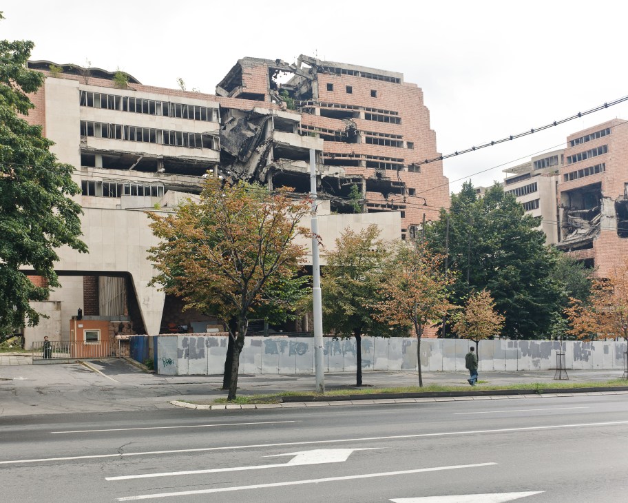 Damaged Ministry of Defence building in Belgrade with boarded windows and destroyed facade from 1999 NATO strikes.