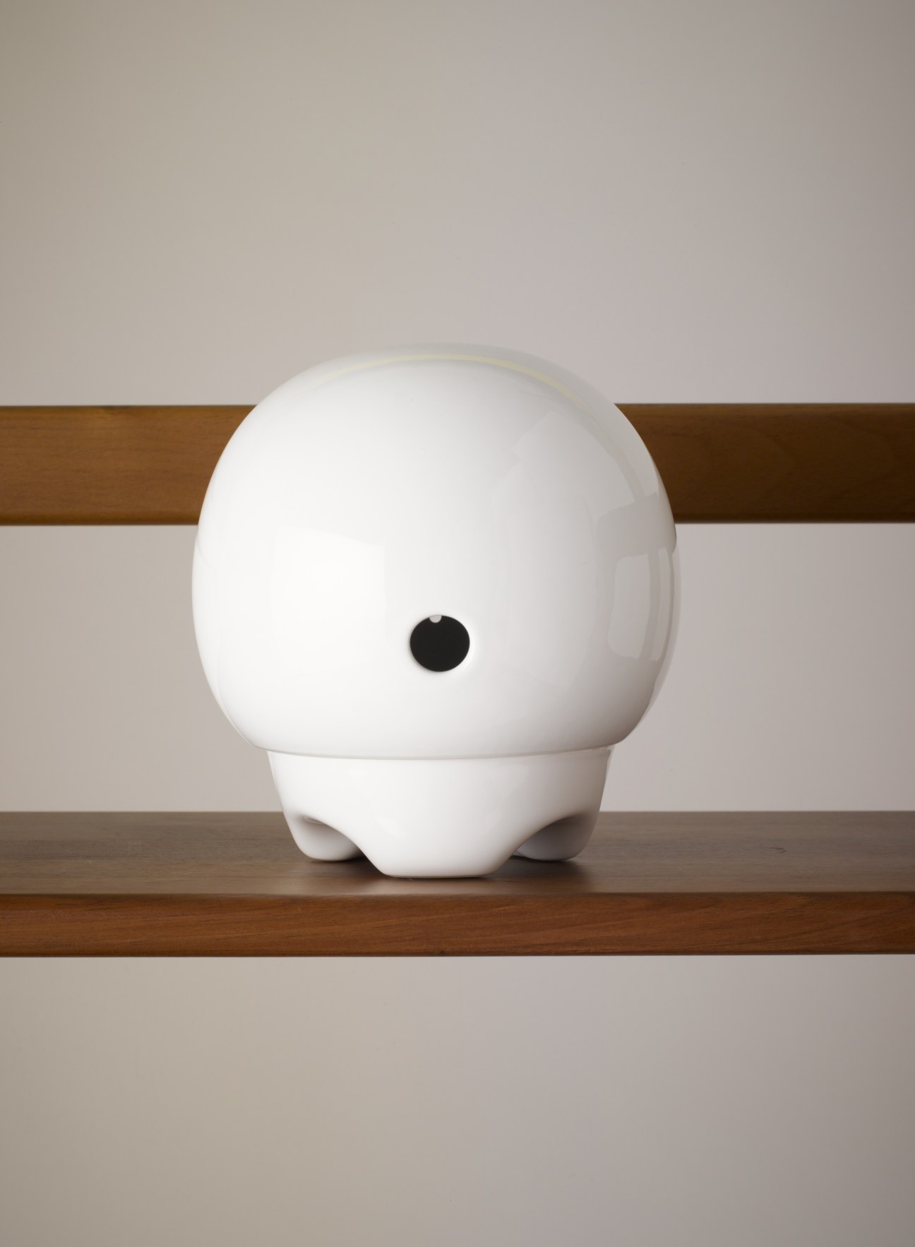 White earthenware Bee Station globe with small entrance hole and feet for water reservoirs.