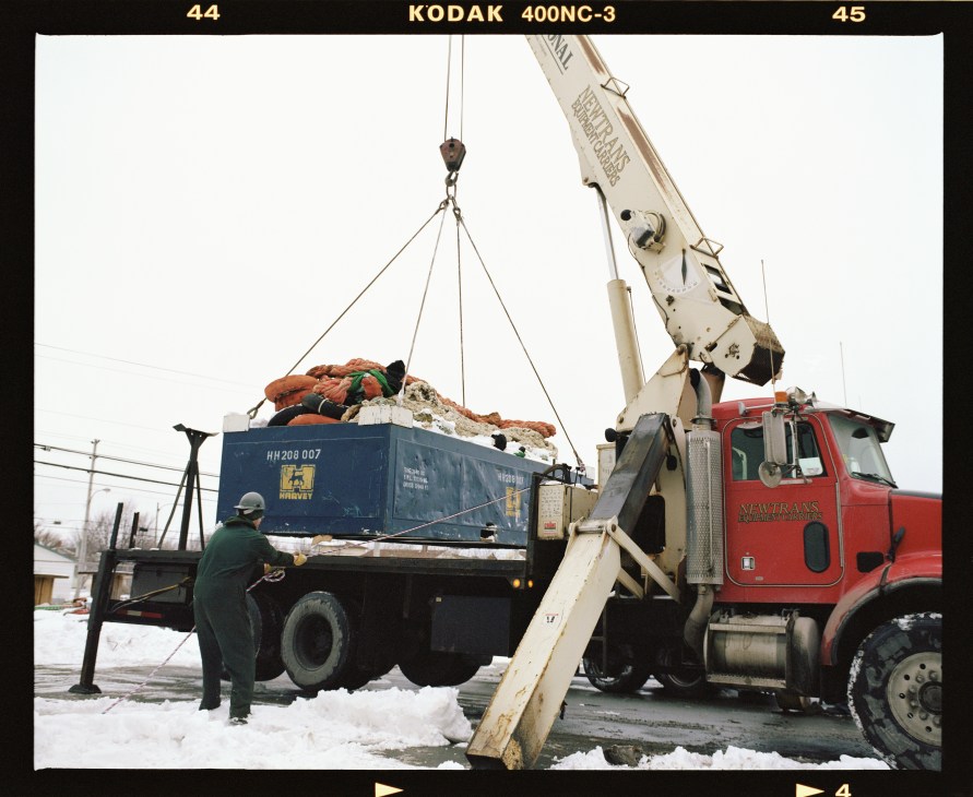 A crane lifts a nine-tonne iceberg net onto a truck at Extreme East Rigging Services in Newfoundland.