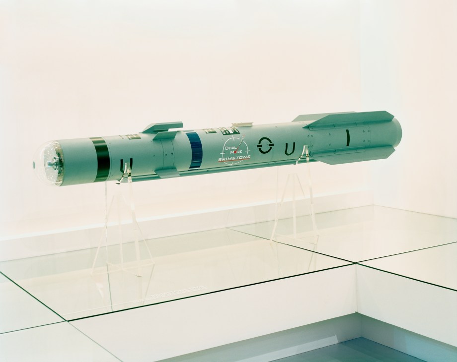 Green Hellfire missile on display stand at arms fair exhibition