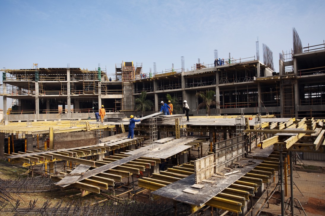 Construction workers on scaffolding at a large commercial building site under development in Maputo.