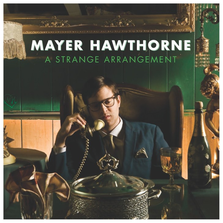 Mayer Hawthorne album cover for A Strange Arrangement showing a man in glasses and suit holding a retro telephone in a vintage-styled room