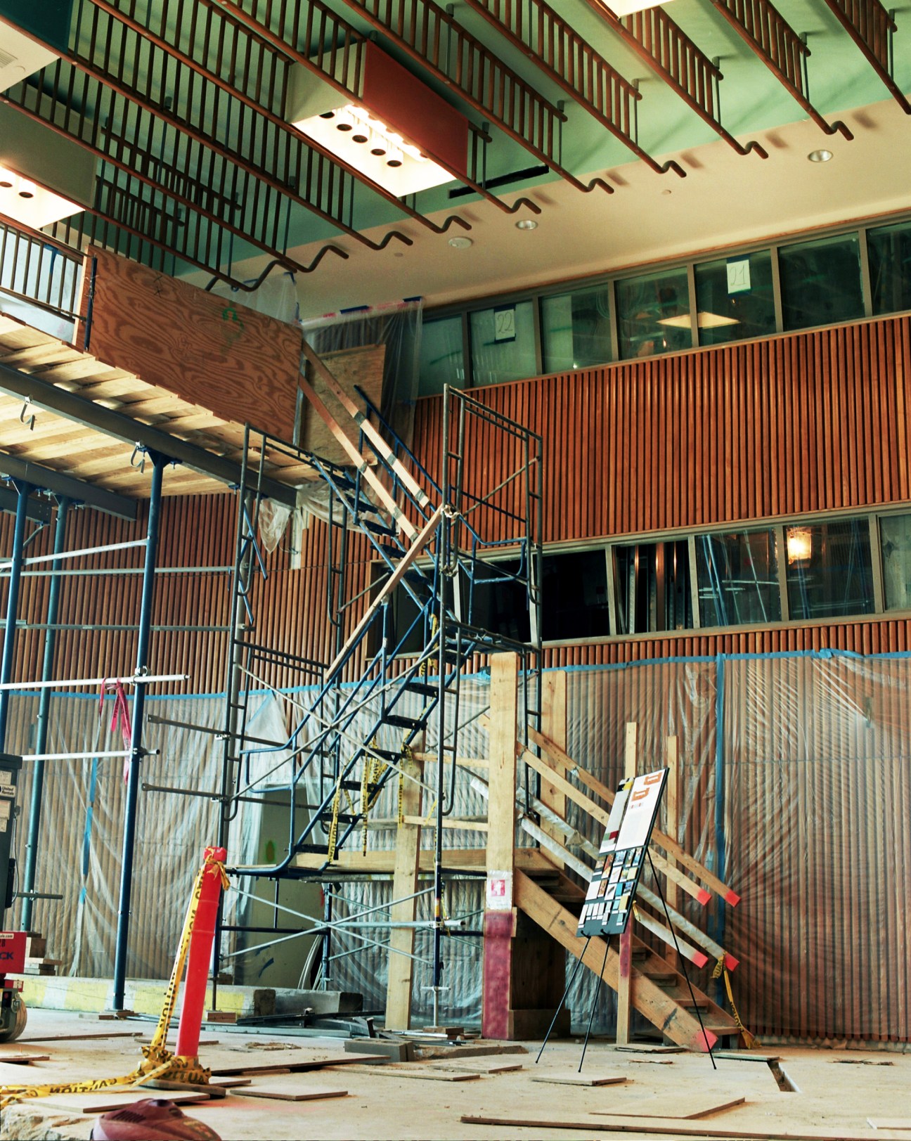 Interior construction site of the Trusteeship Council Chamber with scaffolding, wood panelling, and ornate ceiling details under renovation.