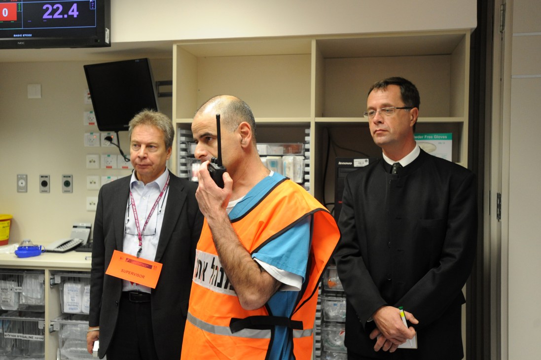 Dr Hany Bahouth and Prof Ari Leppaniemi stand in a hospital control room during a NATO mass casualty training course.
