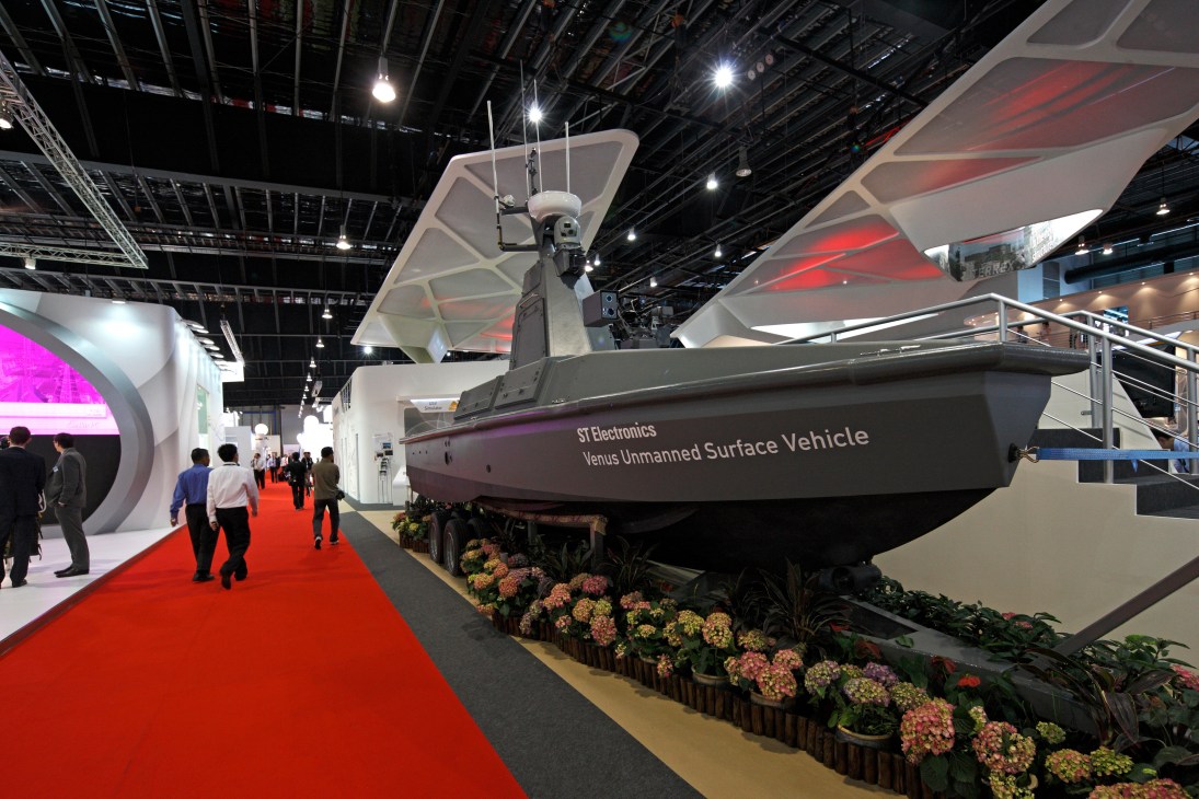 ST Electronics Venus unmanned surface vehicle displayed at Singapore Air Show exhibition with red carpet and visitors
