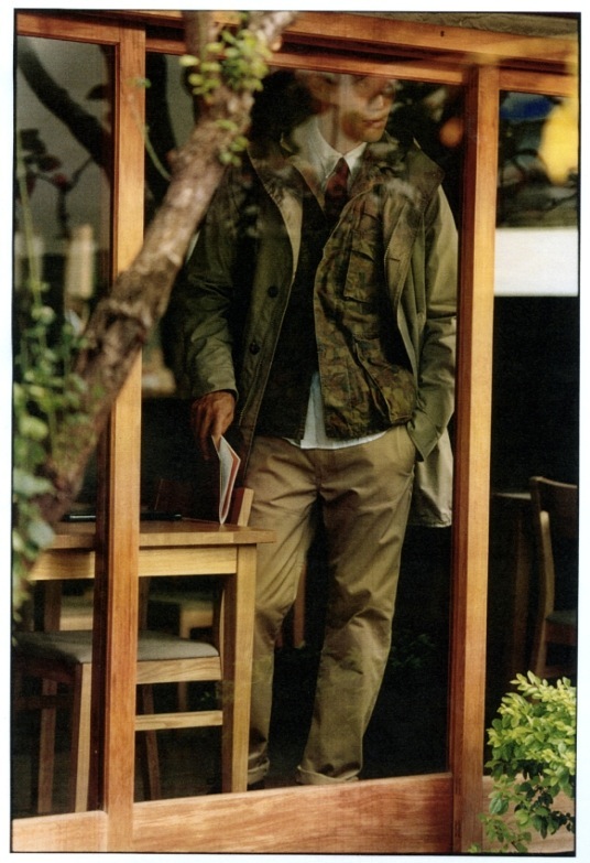 Model wearing Moncler coat, Sage de Cret jacket, and Woolrich Woolen Mills shirt in Fukuoka shop window.