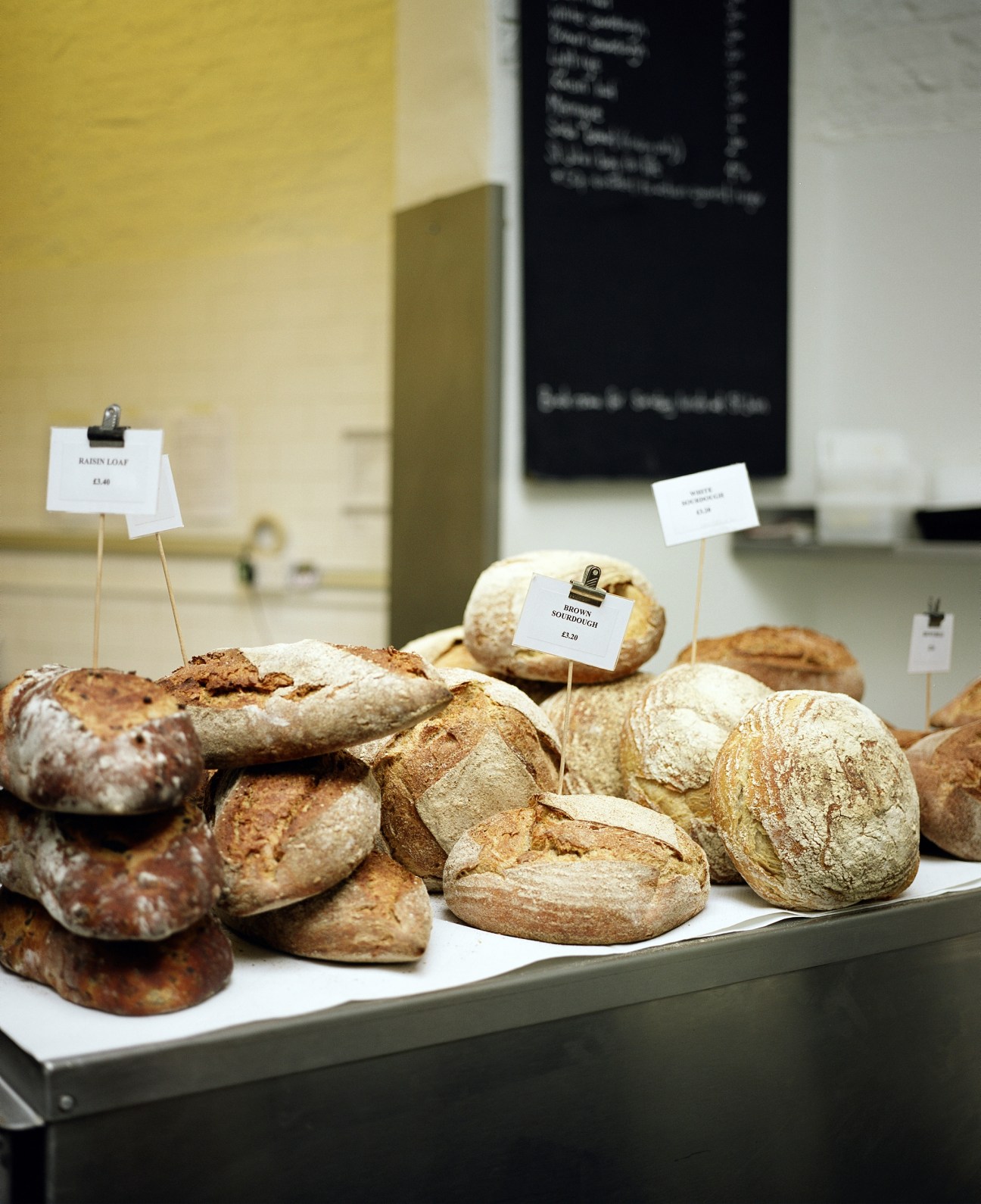 Display of artisan breads with price labels at St John bakery in Smithfield.