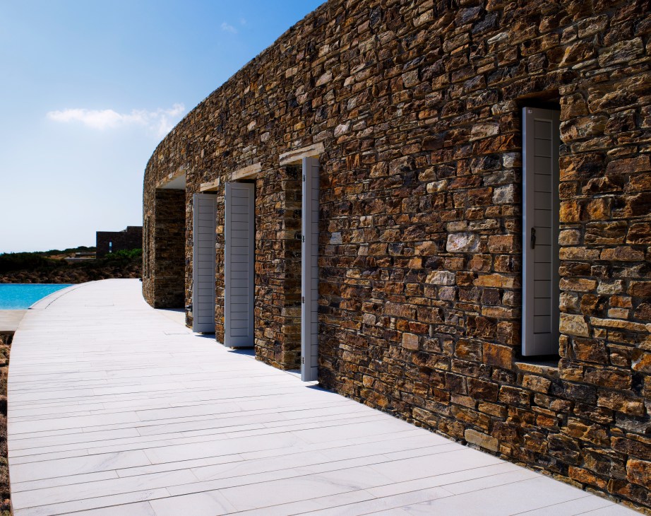 Stone residence with white wooden deck and pool on Greek island of Antiparos.