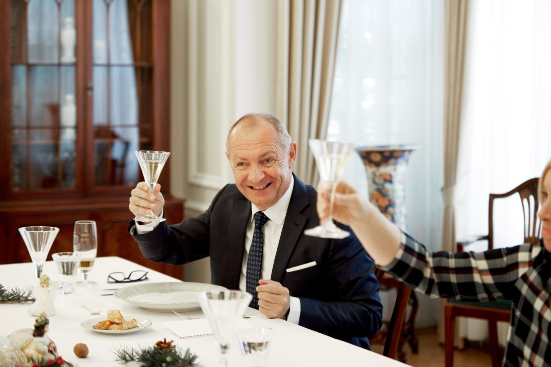 Czech Ambassador Libor Secka raises a glass of white wine in a toast during a festive lunch.