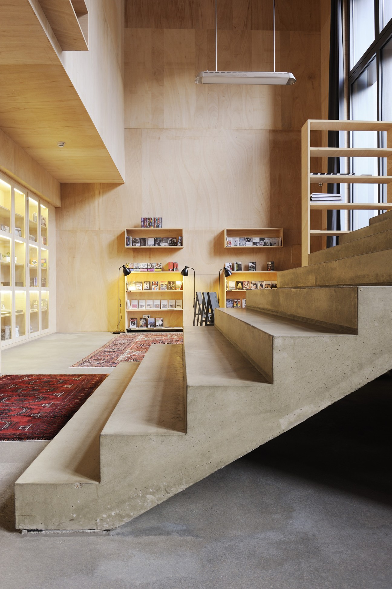 Interior of Image Movement DVD shop with wooden walls, shelving, and concrete seating.