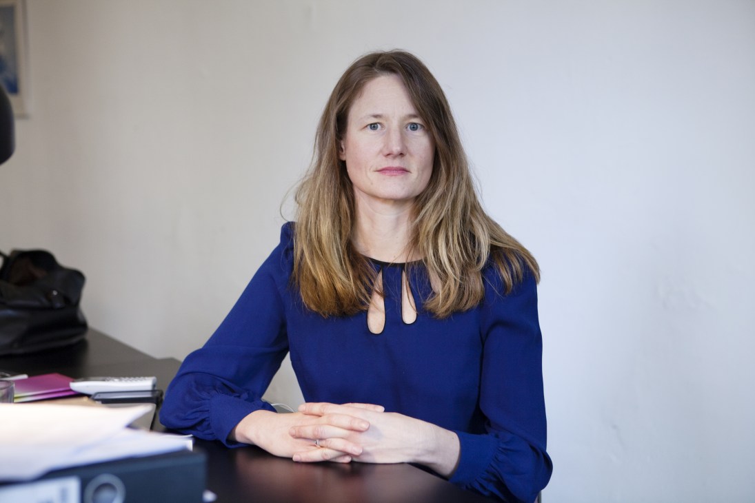 Vanessa Adler, founder of argobooks, sits at her desk wearing a dark blue blouse.