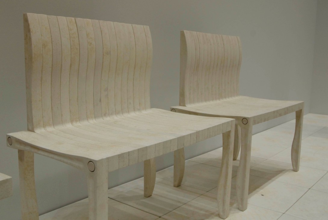 Two light wooden chairs with curved slatted backrests and simple cylindrical legs, part of Artek's modular 10-Unit system.