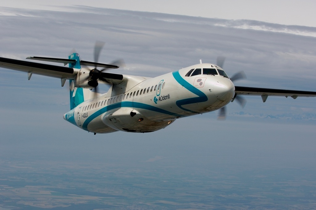 Air Dolomiti turboprop aircraft in flight with teal and white livery.