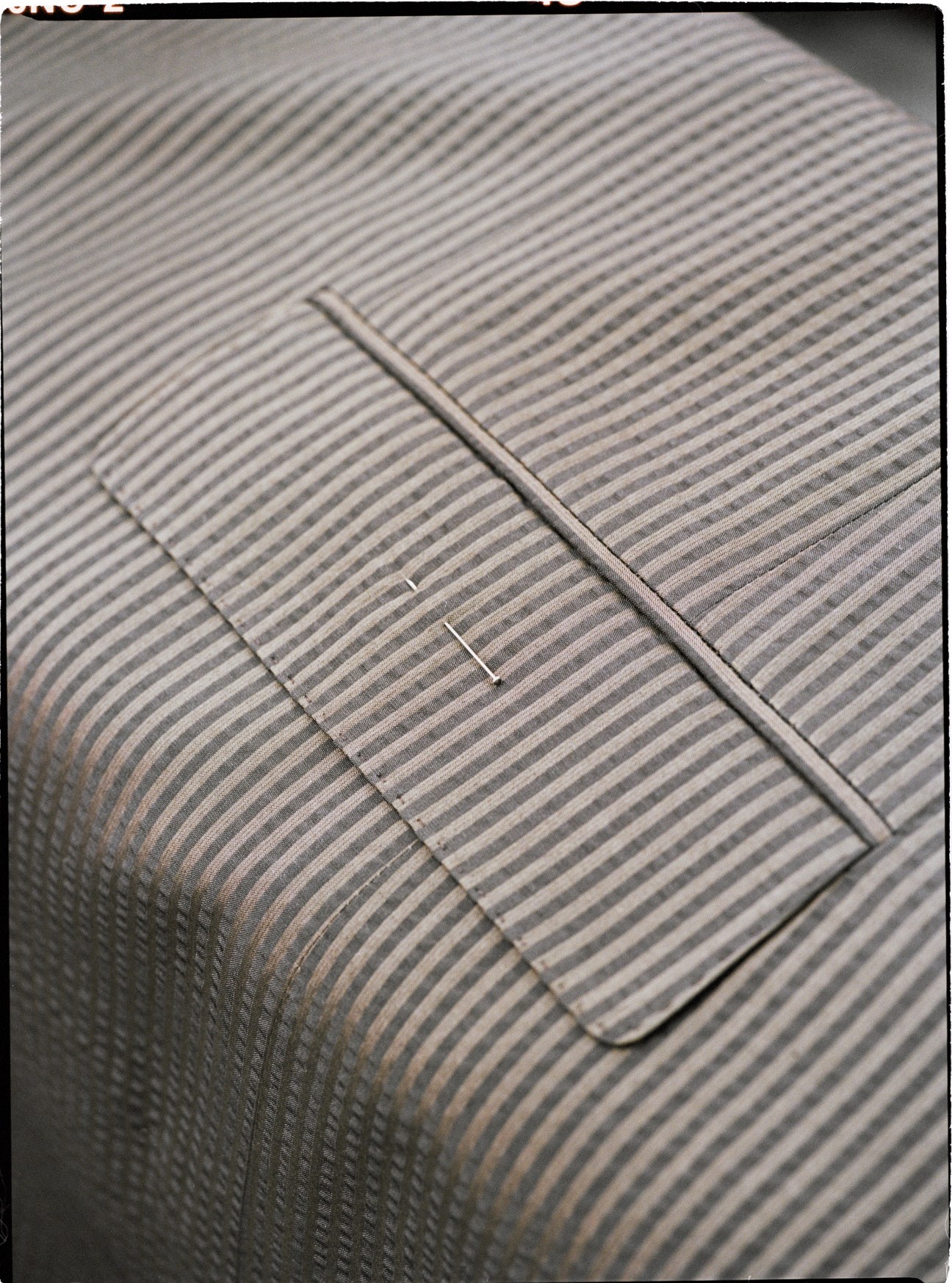 Close-up of precisely matched striped fabric patterns on a Regent suit.