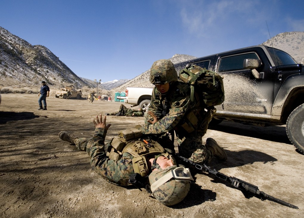 A Marine provides medical treatment to a simulated casualty during a training exercise in Nevada.