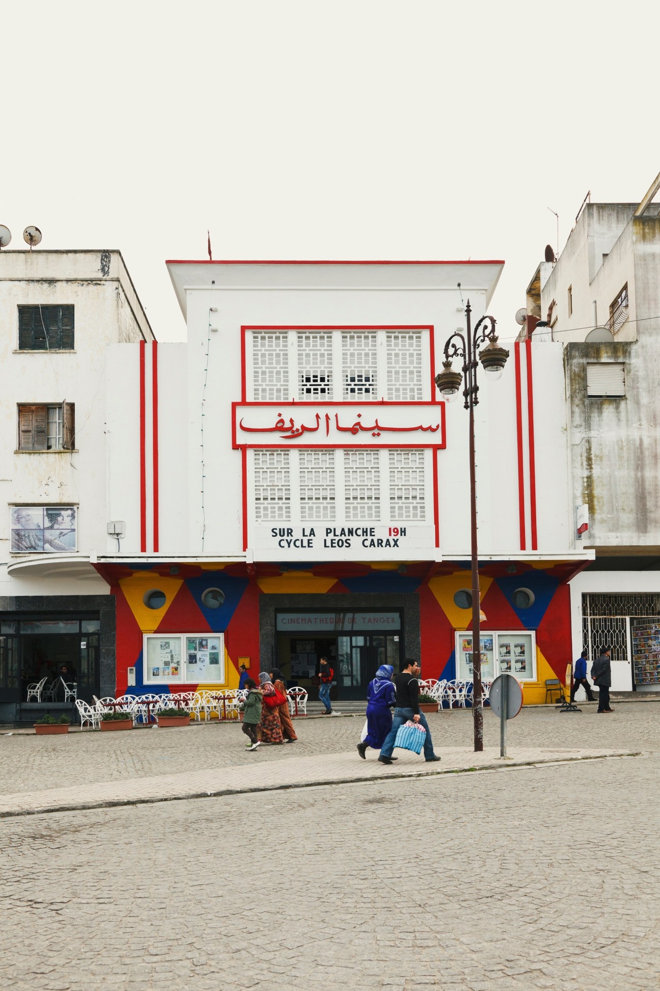 Colorful red, white and blue art deco cinema facade with Arabic signage for Cinema Rif in Tangier.