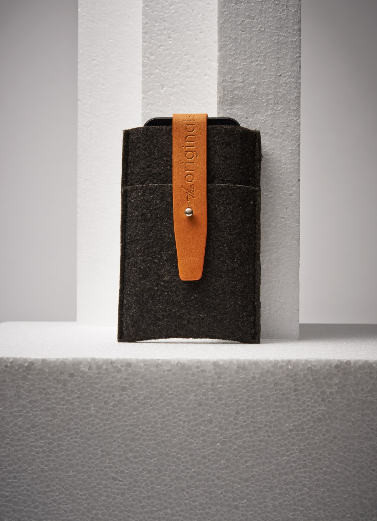 Mujjo iPhone 5 wallet in dark wool felt with tan leather strap.
