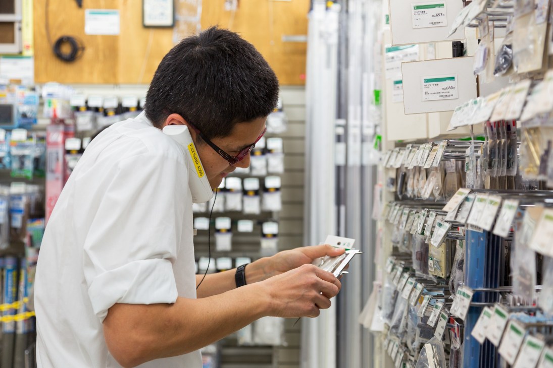 Tokyu Hands employee Hayato Sakuma examines packaged items in the emergency disaster supplies section.