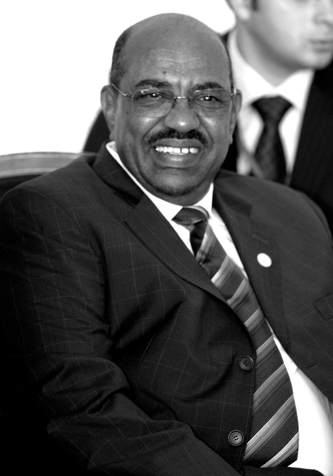 Black and white portrait of Sudan's President Omar al-Bashir in formal business attire.