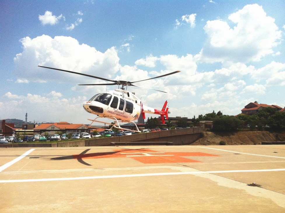 er24 air ambulance helicopter landing on a helipad in South Africa.