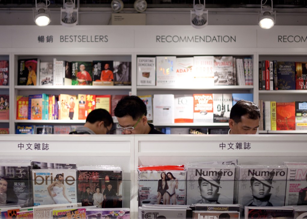 Page One bookstore kiosk displaying bestsellers and recommendations with organized shelving and signage.