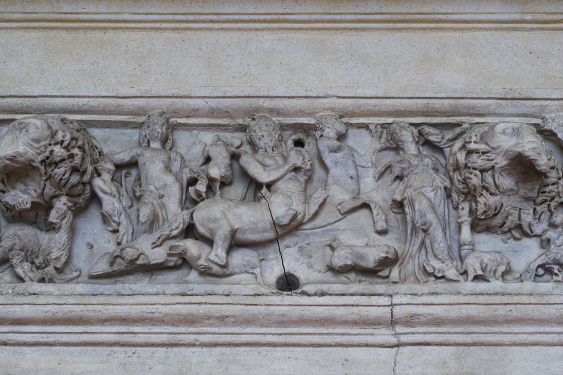 Ornate stone relief carving from the 1640s depicting classical figures and horses.