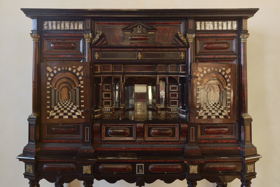 Ornate wooden dresser with intricate inlay work and gold decorative elements in the Sala dei Paesaggi.