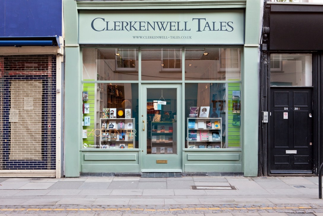 Storefront of Clerkenwell Tales bookshop on Exmouth Market, London, with pale green facade and display windows.