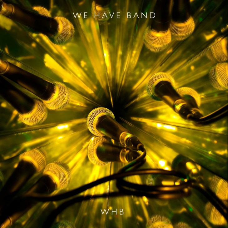 We Have Band album cover featuring illuminated yellow microphones arranged in a radial pattern with glowing light effects.