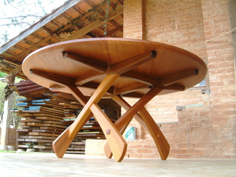 Sculptural wooden table with curved top and twisted X-frame base by Morito Ebine.