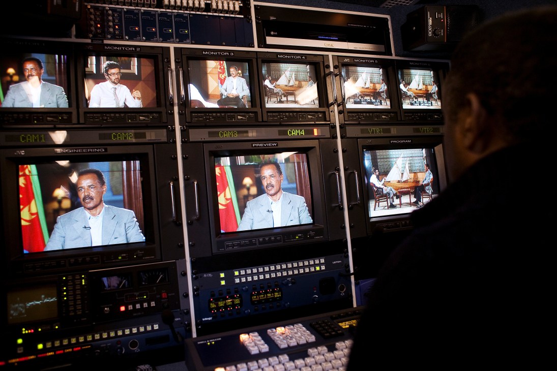 President Isaias Afwerki appears on multiple monitor screens in an EriTV control room during a broadcast.