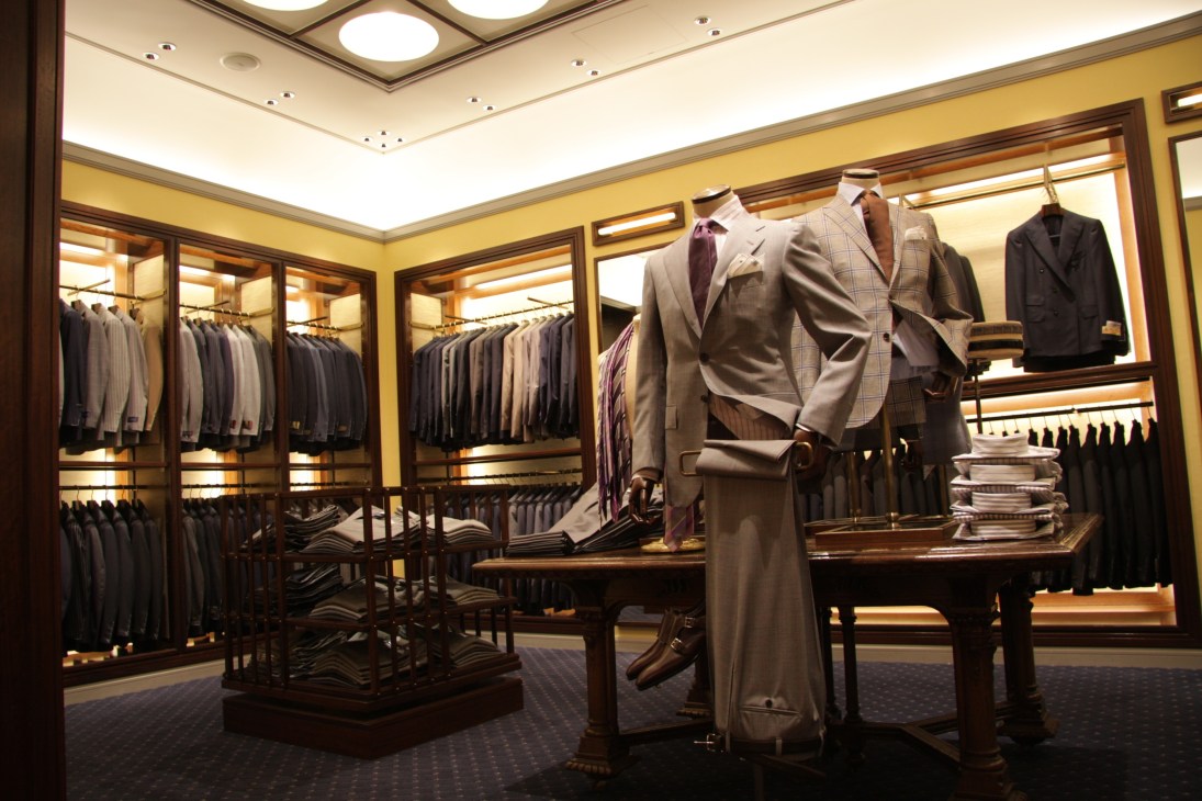 Interior of Beams House retail store displaying men's suits and menswear on mannequins and hanging racks.