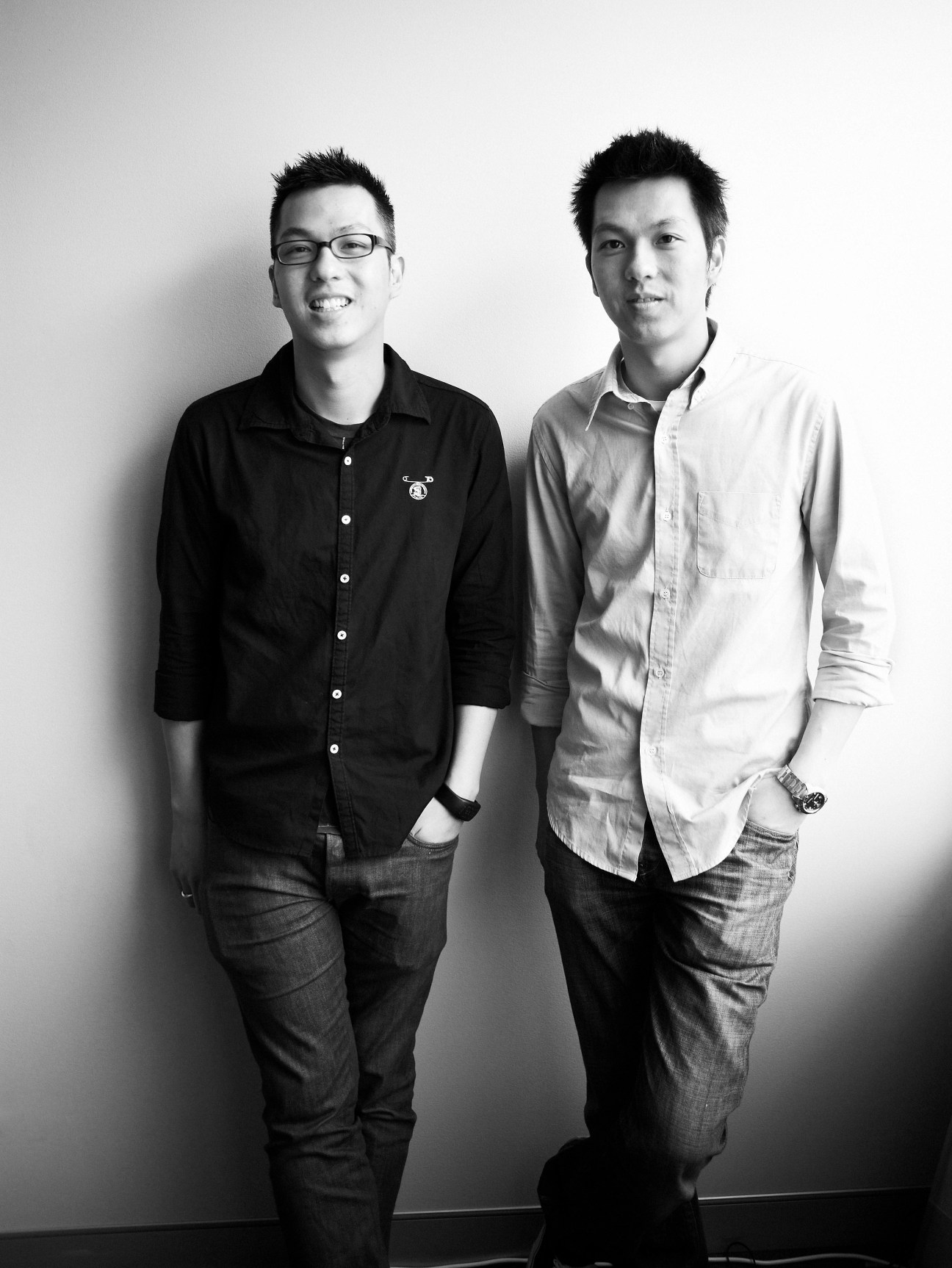 Twin brothers Brian and Vincent Wu, founders of Australian fashion retailer Incu, pose together for a portrait photograph.
