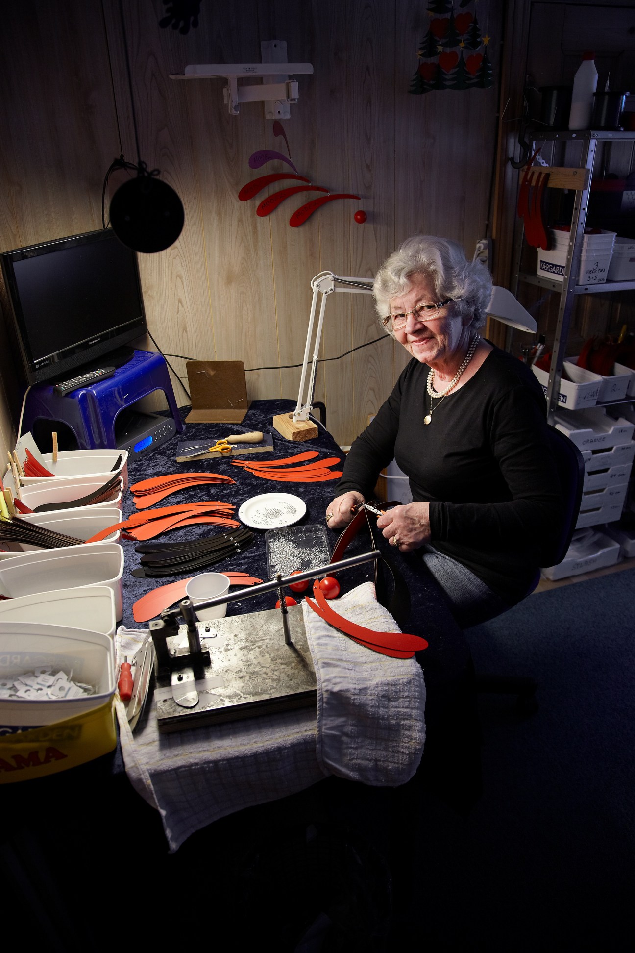 Bendte Mariager, a 66-year-old local mobile maker, works on Flensted mobile components at her workstation.