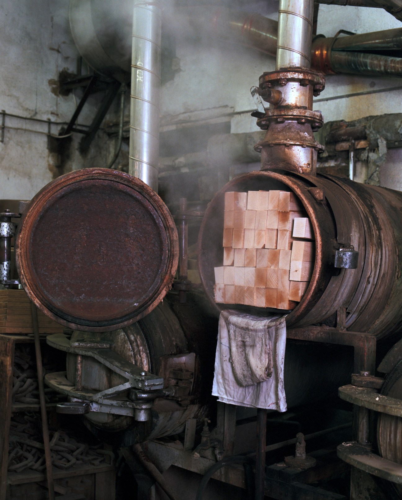 Wood strips being steamed in large metal containers at Horgenglarus bending workshop.