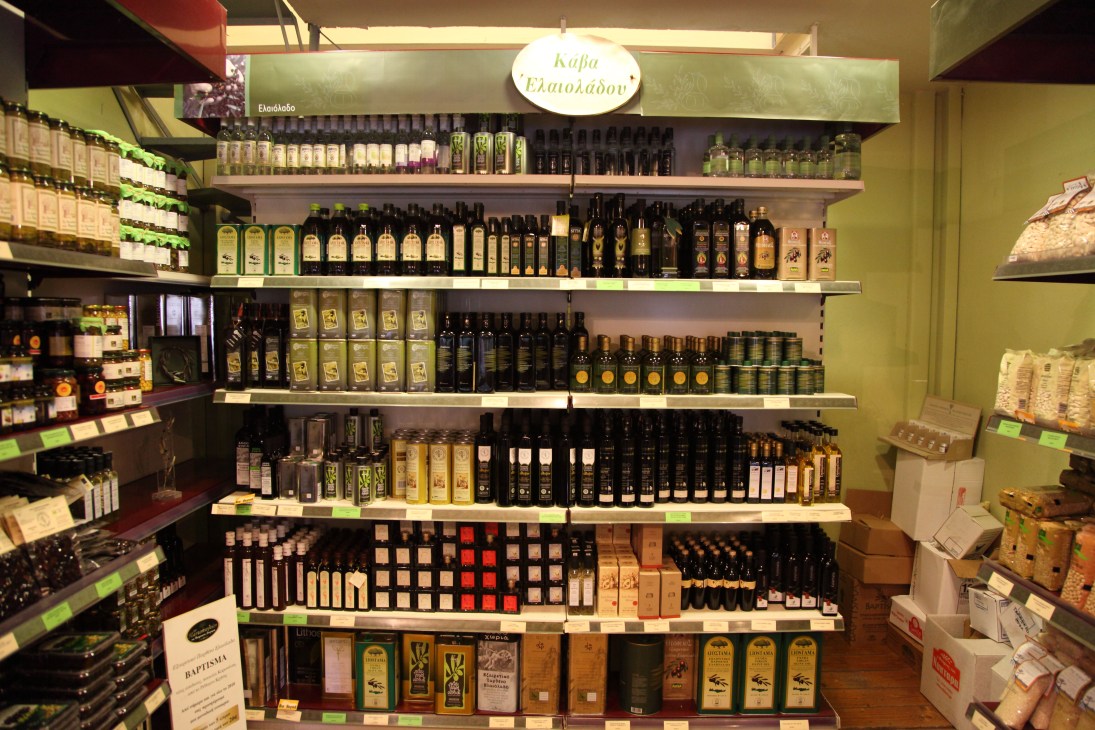 Shelves of bottled olive oils at To Pantopoleion store in Athens