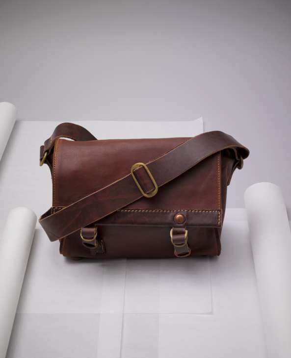 Nivaldo de Lima's Ipé messenger bag in washed buffalo leather with brass buckles and shoulder strap.