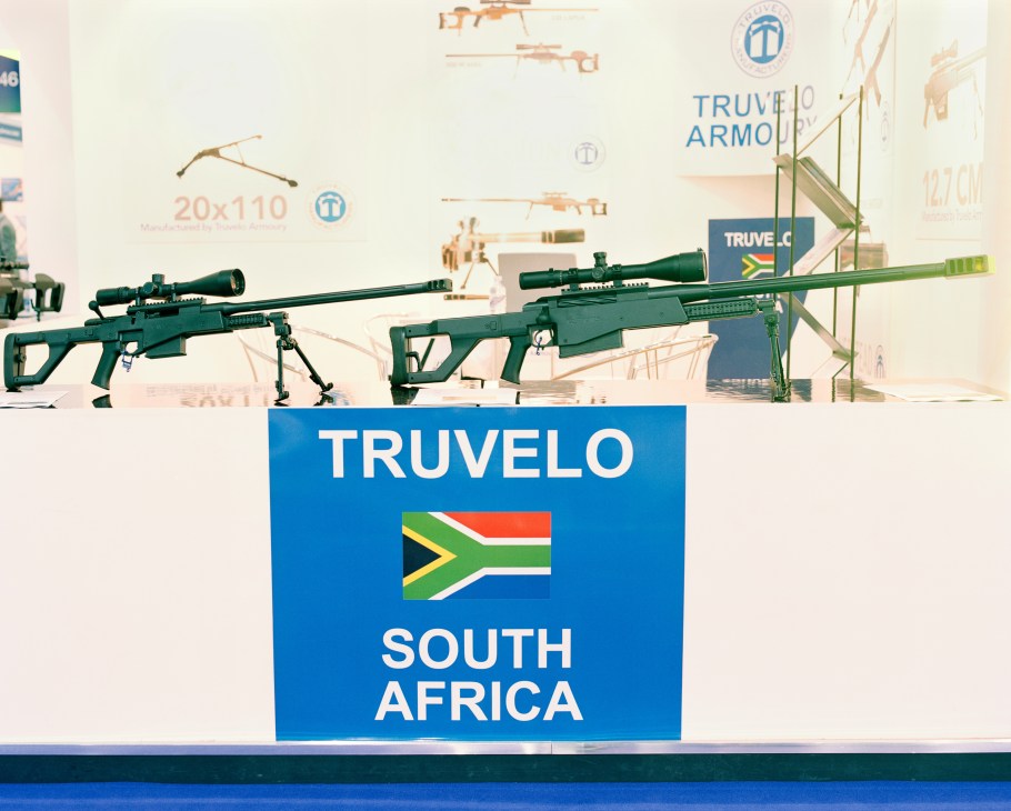 Two green sniper rifles with scopes displayed at a Truvelo South Africa arms fair booth.