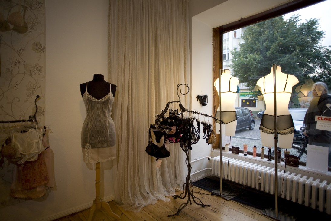 Fishbelly lingerie boutique interior displaying designer underwear on mannequins and dress forms with window view.