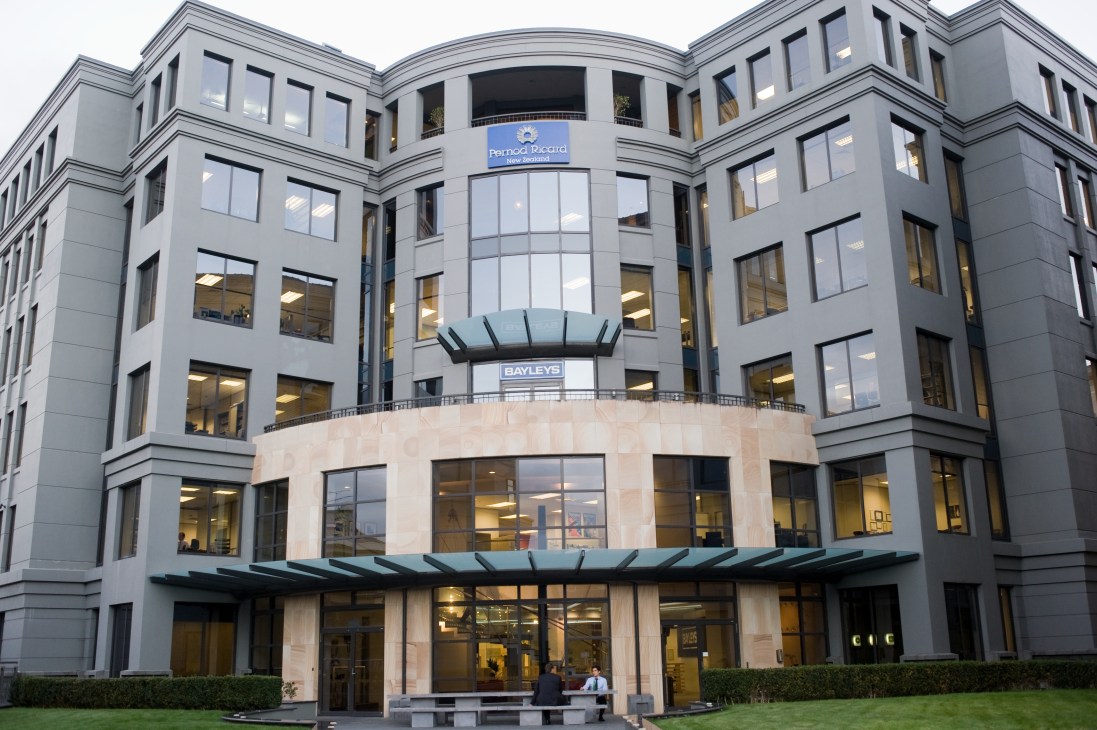 Modern multi-story office building with Bernard Picard and Bayleys signage on facade.