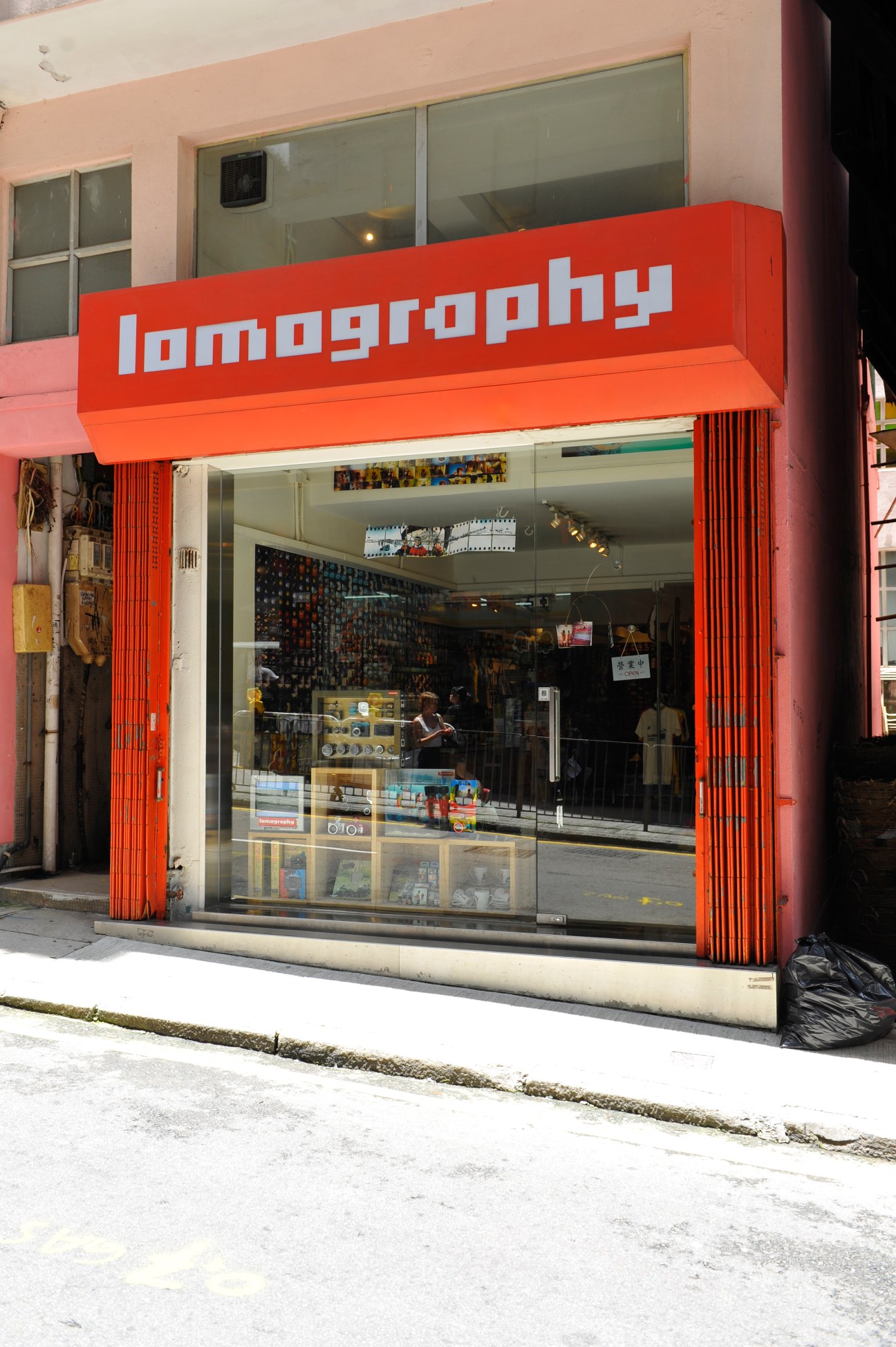 Lomography camera store storefront with bright red signage and display windows in Sheung Wan.