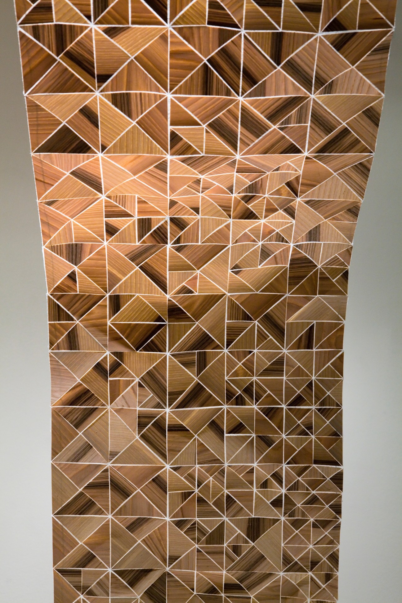 WOODish wooden fabric by Alex Gunnarsson featuring geometric triangular patterns with white lines on wood grain.